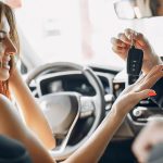 Stylish and elegant couple in a car salon